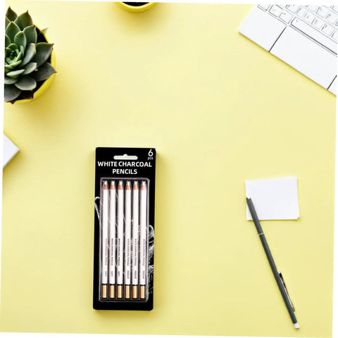 Six Piece White Sketch Pencils Set For Charcoal Drawing Artists And Newbies Soft Medium Hard Graphite For Shading Blending And Texturing Art Supplies Essentials on a yellow desk