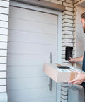 Delivery person using video doorbell with Adjustable Angle Mounting Bracket For Video Doorbell 2021 Black No Fuss Easy Install