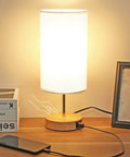 Sleek Bedside Lamp With USB C And USB A Ports, Touch Controlled Table Light With 3 Lighting Modes, LED Bulb, on a wooden desk