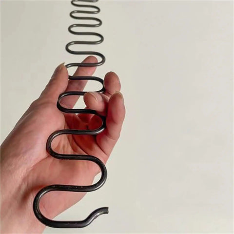 Top Notch Zig Zag Sofa Springs With Clip And Nail Kit For Saggy Chair Repair and Furniture Restoration shown in hand.