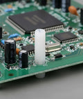 Top Shelf M4 X 12mm Nylon Slotted Set Screws on a circuit board, used for non-conductive electronics fastening.