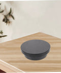 Electric Rotating Jewelry Display Turntable Motorized Showcase Stand For Photography Props With Rechargeable Battery, black PVC base on wood surface.