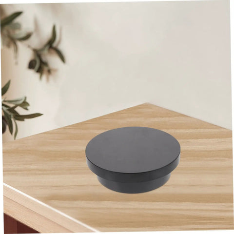 Electric Rotating Jewelry Display Turntable Motorized Showcase Stand For Photography Props With Rechargeable Battery, black PVC base on wood surface.