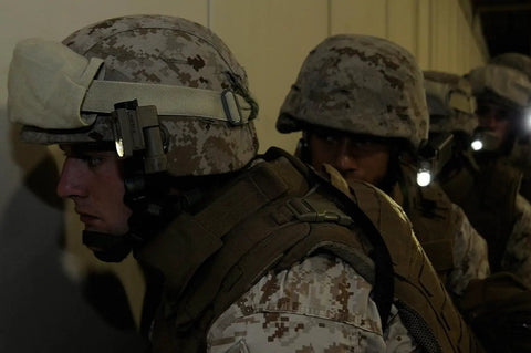 Military personnel wearing Sidewinder Compact 55 Lumen Hands Free Military Tac Ready Flashlight With Helmet And MOLLE Mount.