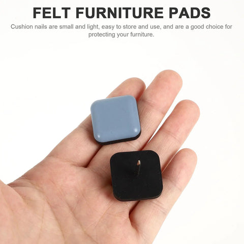 Hand holding grey and black PTFE chair glides from 16 Pack Chair Glides And Furniture Sliders For Hardwood And Linoleum Floors, PTFE And Iron Material, No Squeak Noise Reducing Floor Protectors, Easy Drill In Install, Smooth Movement, Floor Safe For Dining Sets Desks And Chairs.