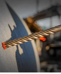 Diablo SDS-Plus hammer drill bit with orange carbide 4-cutters, 3/4 in diameter, close-up of spiral flutes