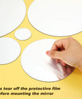 32 Piece Removable Acrylic Mirror Wall Stickers Round Tiles Silver Medium Size being peeled