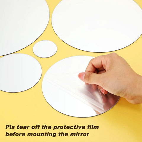 32 Piece Removable Acrylic Mirror Wall Stickers Round Tiles Silver Medium Size being peeled