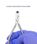 Pro Grade Tungsten Carbide Distal End Cutter for Orthodontics, 5.5 Inch Wire Cutter With Flush Trim, Cuts Hard Archwires Up To 0.022 By 0.028 Inch, Precision Pliers, Stainless Autoclavable Dental Tool, held in gloved hand