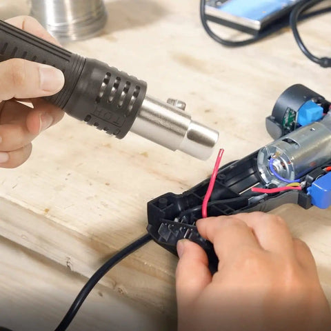 Hot Air Rework Station For Electronics Repair With Digital Display Heat Gun, Three Temperature Presets, tool in use on PCB