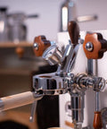 Espresso machine with bottomless 58mm portafilter for E61 grouphead, stainless steel body, zebra wood handle, filter basket included.
