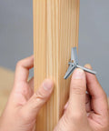 Person installing Wing Nut And Toggle Bolt Kit With 20 Metal Drywall Anchors And 1 Eighth Inch Thread Inserts on wood