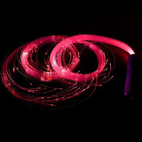 Lit Fiber Optic Space Dancing Light Whip with Rechargeable LED glowing in red, showing fiber optic strands, ideal for EDM parties.