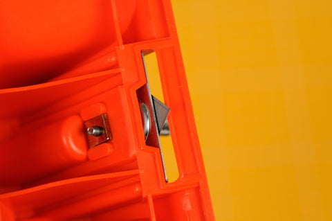 Close-up of blade in red Mat Board Cutter 45 Degree Bevel For Precise Framing Aluminum Die Cast Grip NT Professional MAT45P with yellow background.