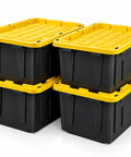 Rock Solid Heavy Duty Storage Totes With Secure Lids 27 Gallon 4 Pack Stackable Plastic Bins 100 Pound Capacity in black with yellow lids.