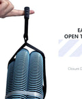 Two Pack Heavy Duty Cord Storage Wrap Holder with hook and loop strap holding blue coiled hoses, finger holding carrying strap.