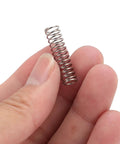 Game Changer 304 Stainless Steel Coffee Machine Pressure Springs held between fingers for espresso machine upgrade.