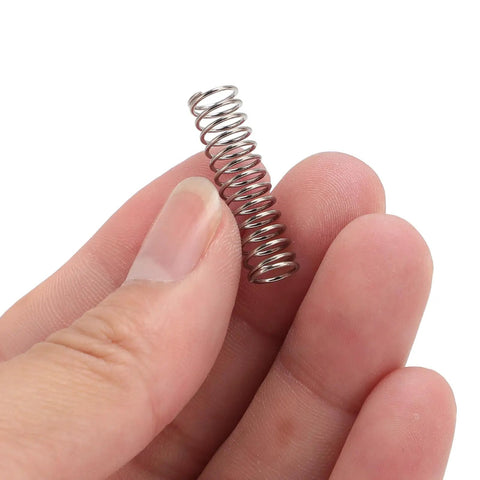 Game Changer 304 Stainless Steel Coffee Machine Pressure Springs held between fingers for espresso machine upgrade.