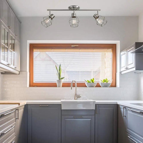 Cedrick 3 Light Track Lighting In Brushed Nickel above modern kitchen sink, adjustable heads, vintage Edison bulbs, farmhouse style.