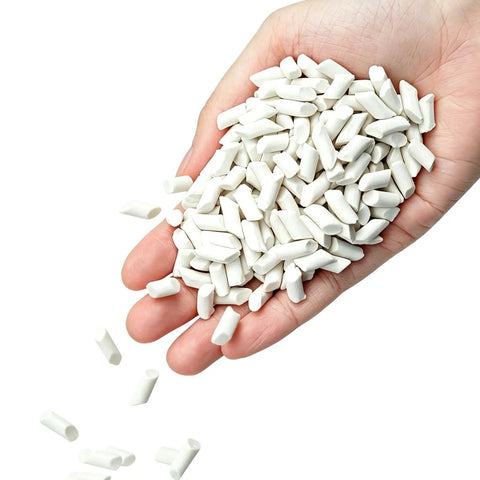 Hand holding Eight Pound Ceramic Tumbling Media Cylinders, Reusable Non Abrasive Pellets 1/5 x 2/5 Inch For Lapidary Tumblers And Stone Polishers