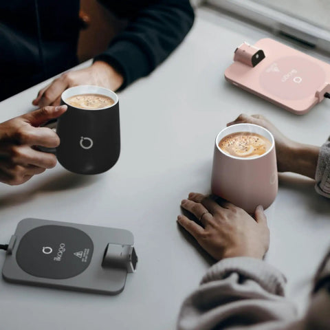 Level Up Your Morning Vibe This Smart Mug Warmer Game Changer Keeps Your Daily Brew Piping Hot With Precision Temp Control 15 Oz Ceramic Mugs Lids And Spoons Simple Cord Setup, showcasing black and pink ceramic mugs with a grey warming base.