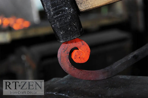 Farmhouse Style Matte Black Wrought Iron Towel Holder being hand forged, showing the glowing red metal curl detail in workshop.