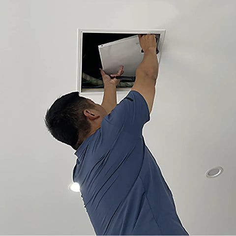 Man installing Super Slick Ceiling Access Panel For Drywall With Heavy Duty Aluminum Frame And Paint Ready White No Hassle Recessed Hatch Cover.