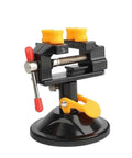 Super Durable Cast Iron Small Bench Vise With Suction Cup Flat Jaws And Precision Clamping Power For Hardwood Carving DIY Projects At Home Workshop Or Garage Table Use showing a close-up with a suction base and adjustable jaws.