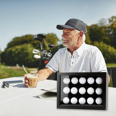 Man enjoying drink outdoors next to Top Notch Wood Golf Ball Display Case For 15 Balls, Wall Mount Or Freestanding Shadow Box With EVA Foam Protection