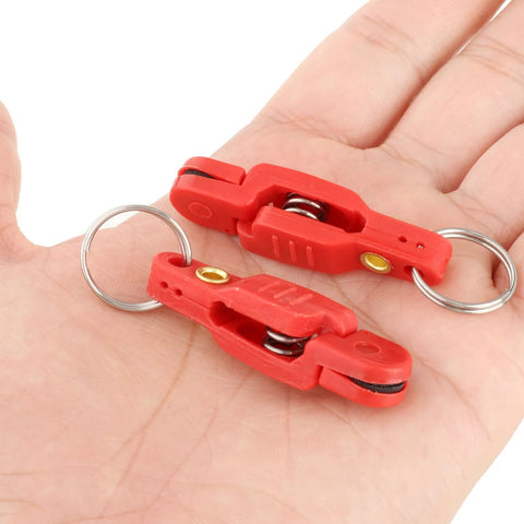 Red plastic downrigger release clips with springs and metal key rings (2 shown)