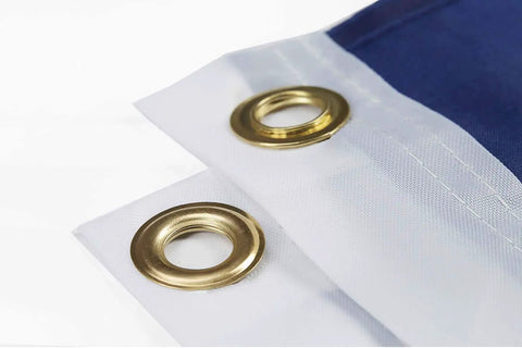 Close-up of double-stitched edge and brass grommets on 2x3 Indoor Outdoor US Flag made from polyester nylon.