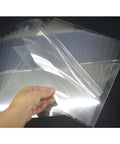 Front view of ZHluja 10-pack 12x12 clear stencil sheets, 10 mil PET/Mylar, held in hand