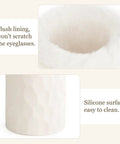 Close-up of ivory plush-lined eyeglasses holder interior and silicone surface, part of the Plush Lined Eyeglasses Holder And Glasses Stand For Desk Or Nightstand Slick Easy Access Anti Scratch Protective Case Tabletop Storage Organizer In Ivory One Size For Office Use.