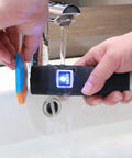 Rugged IP67 Waterproof 125kHz RFID Guard Tour System in use under running water, demonstrating waterproof capability.