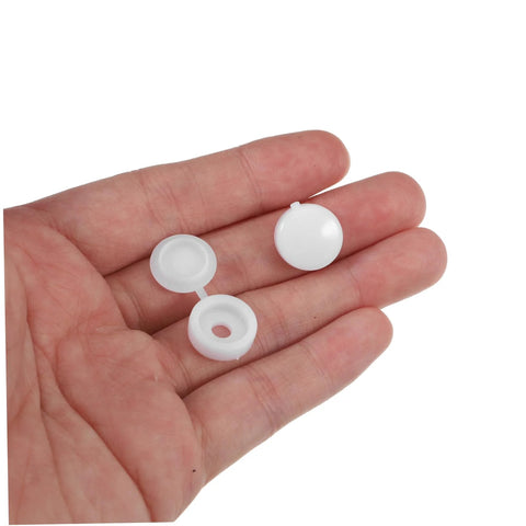 Hand holding white caps from Plastic Screw Cover Caps Set 400 Pieces Hinged Design Multi Color Assorted For Furniture Tables And Cabinets