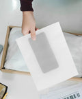 Hand holding 100 Pcs White EPE Foam Pouches Lightweight Shockproof Packing Bags For Electronics And Fragile Items Protective Wrapping For Moving And Shipping Gear Supplies