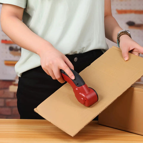 Person using Katerk Cordless Electric Cardboard Cutter 4.4V High Torque Scissors on cardboard box for easy cutting.
