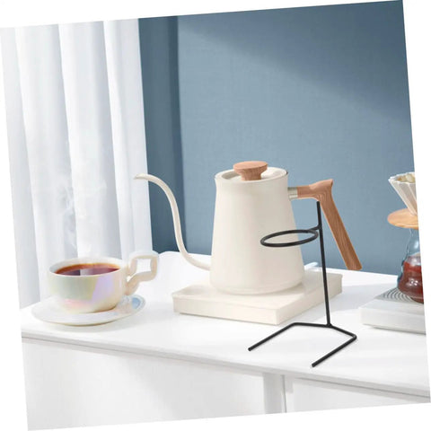Kick Up Your Morning Brew Game With This Slick Two Piece Coffee Dripper Stand. Black steel coffee dripper stand beside cup.