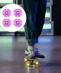Light Up Quad Skate Wheels Set of 4 with Bearings for Indoor and Outdoor Roller Skates, Iridescent Pink Purple Glow displayed with skater