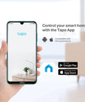 Hand holding smartphone displaying Tapo app for controlling smart home devices, compatible with iOS and Android.