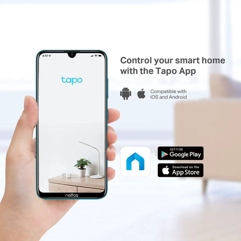 Hand holding smartphone displaying Tapo app for controlling smart home devices, compatible with iOS and Android.