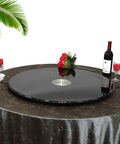 Black Glass Lazy Susan Rotating Turntable on dining table, surrounded by wine, glasses, and flowers; elegant server for dining.