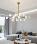 Modern living room featuring a black gold Sputnik chandelier with white globes and adjustable height for dining areas.