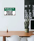 First Aid Station Aluminum Sign 8x12 Inches Dope Wall Decor for Office shown above desk in modern workspace.