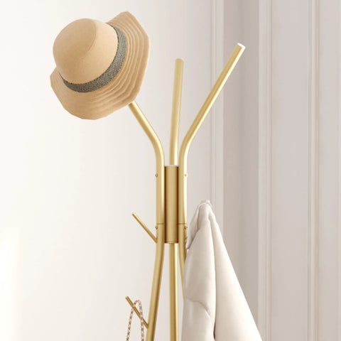 Top view of coat rack with 12 hooks freestanding hall tree in gold finish with hat and coat displayed in modern room.