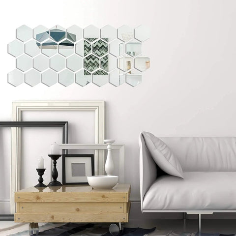 24 Piece Hexagon Acrylic Mirror Wall Decals Set for Living Room above a sofa, showcasing reflective surface and decor upgrade.