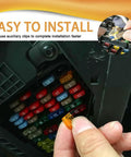 Person holding an orange blade fuse near an electrical box, showcasing the Heavy Duty Car Fuse Assortment Kit with 5A Through 30A.