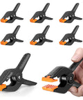 Six Pack Heavy Duty 4.5 Inch Plastic Spring Clamps For Backdrops And Photography Studios, showing clamps with orange tips