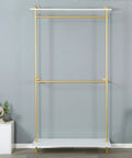 Hella Sturdy Two Tier Industrial Garment Rack With Thick Wood Shelf And Durable Metal Frame Wall Mounted Double Hanging Rods Clothes Storage Shelf For Home Or Boutique, featuring gold pipes and a white shelf.
