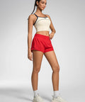 Model wearing Womens Quick Dry Running Shorts 2.5 Inch Inseam With High Waisted Zip Pockets Lightweight Gym Shorts Built In Liner Red XS